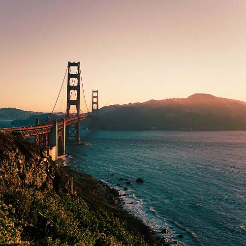 bridge red metal bridge across teal body of water at daytime golden gate bridge